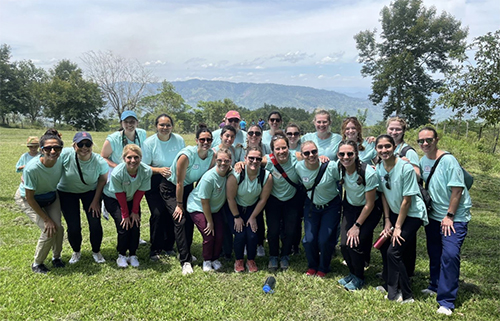 Volunteer group photo in Honduras with beautiful landscape